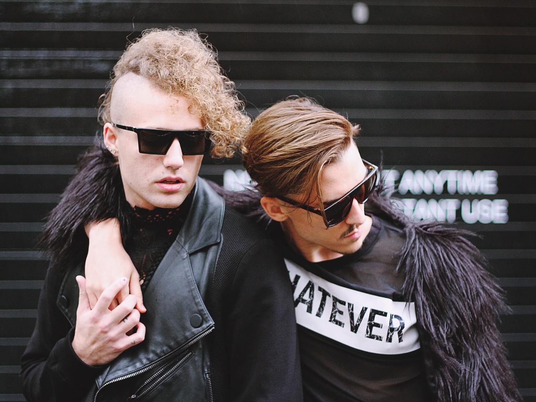 Two young men in black with sunglasses